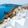 A Greek village built into the hill of a rocky coastline
